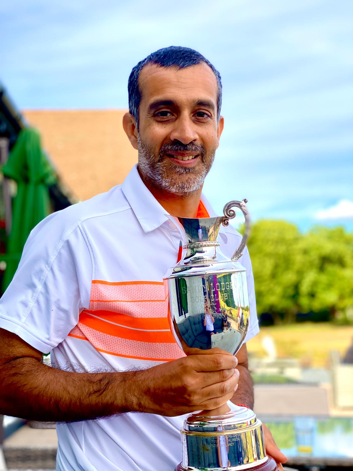 Zaheer holding a trophy at the golf club
